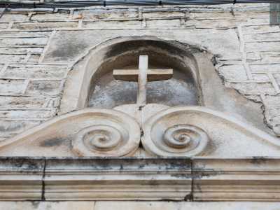 In alto, poco sopra il timpano, sono presenti due volute sulla cui sommit� � presente una nicchia contenente una croce...